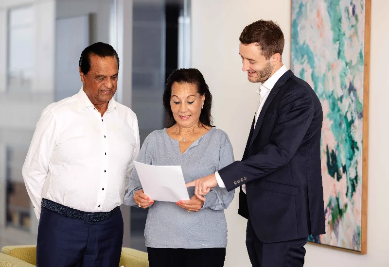 Confident financial advisor speaking with mature couple