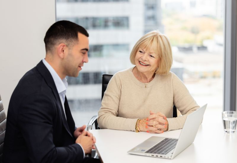 Senior woman seeking advice from adviser